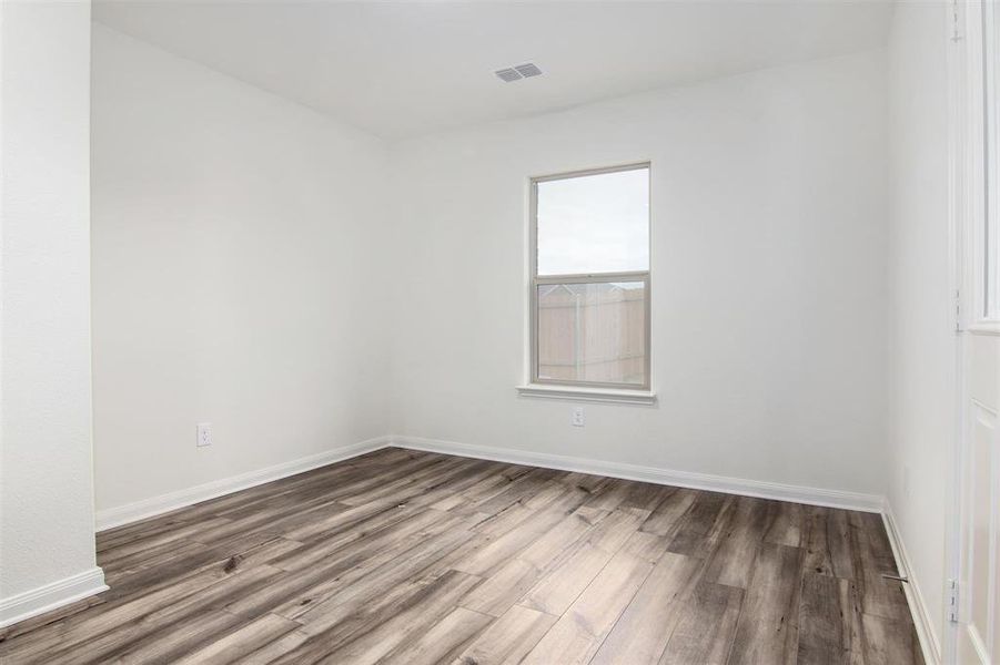 Empty room with dark hardwood / wood-style floors