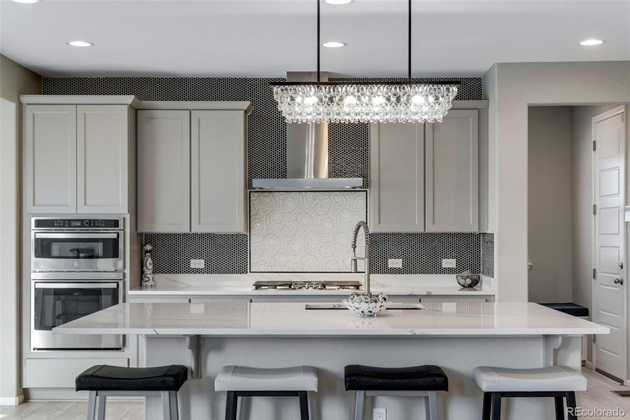 Custom Backsplash with Vent Hood in Gourmet Kitchen