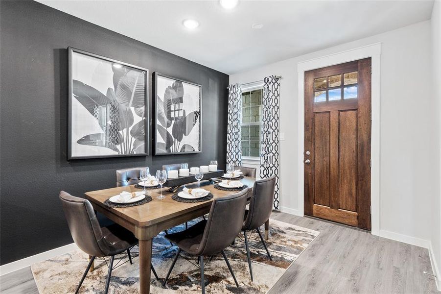 Dining space with light hardwood / wood-style floors