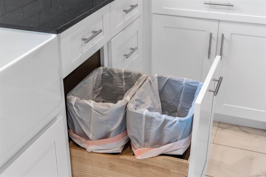 Hidden garbage cans close by to sink