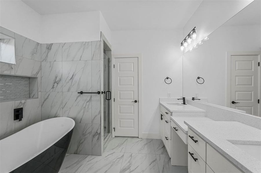 Bathroom with independent shower and bath, vanity, and tile walls