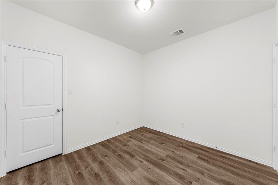 Unfurnished room with hardwood / wood-style flooring