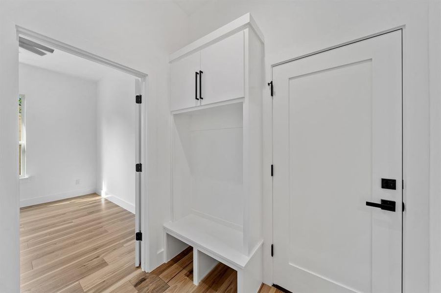 Mudroom with light hardwood / wood-style flooring