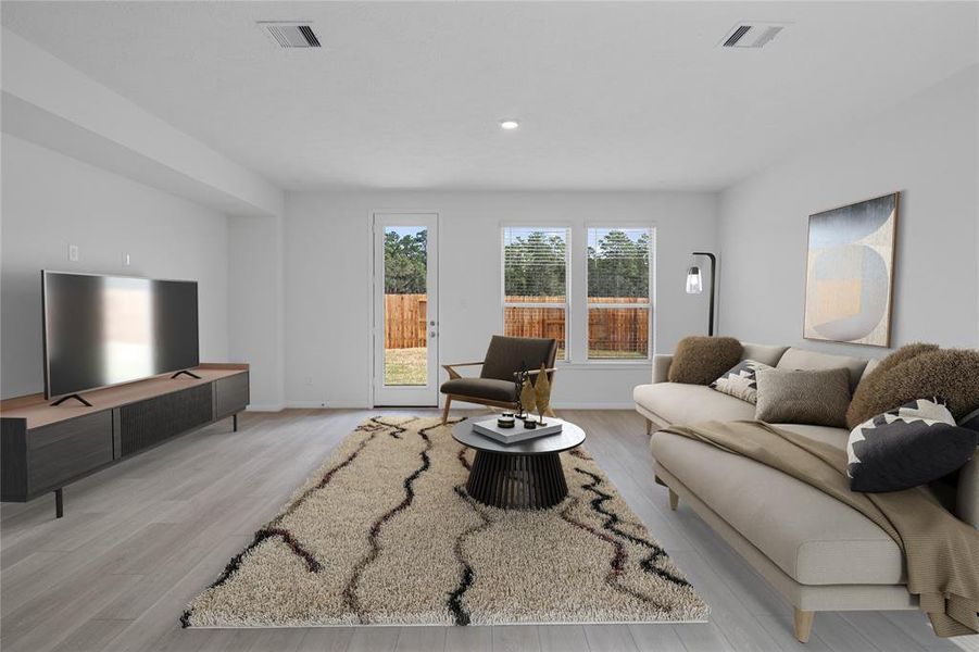 This light and bright spacious family room is the perfect layout for entertaining or just relaxing. Whether it's simply a night in or entertaining family and friends, this home has ample open space for everyone to enjoy! Featuring vinyl plank flooring, large windows, high ceilings, recessed lighting, and wonderful access to your gorgeous kitchen.