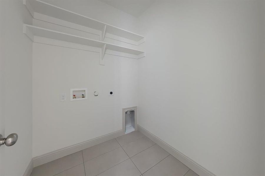 Laundry room featuring electric dryer hookup, hookup for a washing machine, light tile patterned floors, and gas dryer hookup