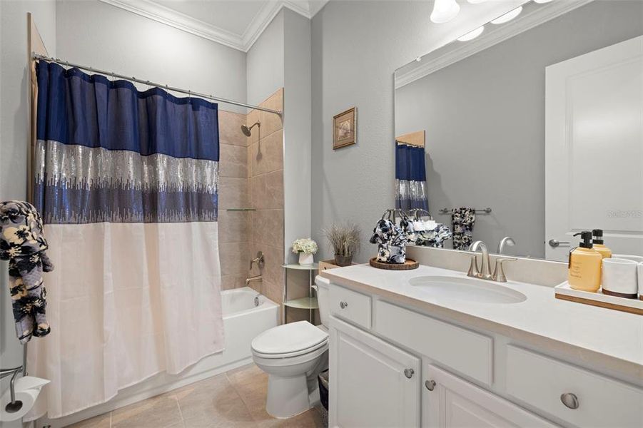 Guest Bathroom with Tiled Shower/Tub Combo & Crown Molding