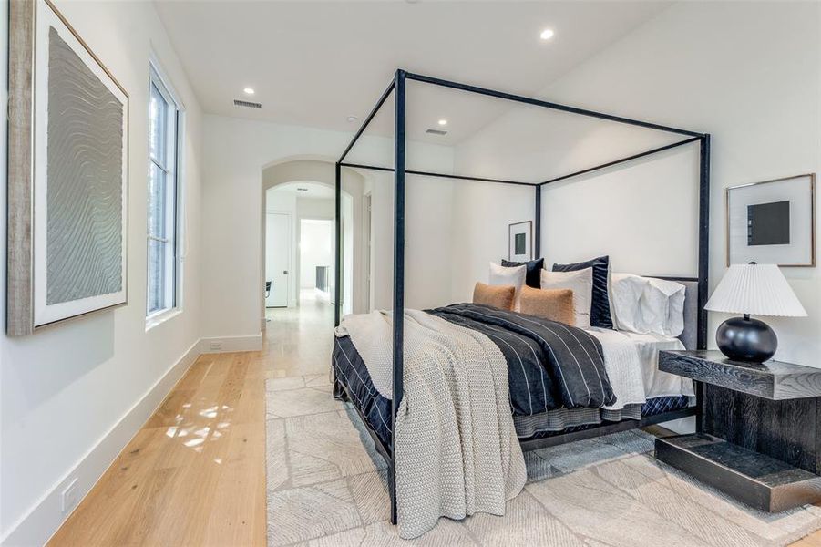 Bedroom featuring light wood-type flooring and multiple windows