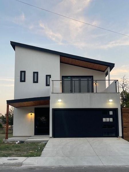 Modern home with a balcony and a garage