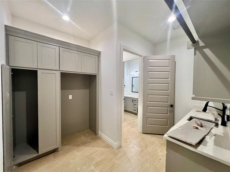 HUGE LAUNDRY ROOM WITH ADDITIONAL BUILT-INS FOR MORE STORAGE.