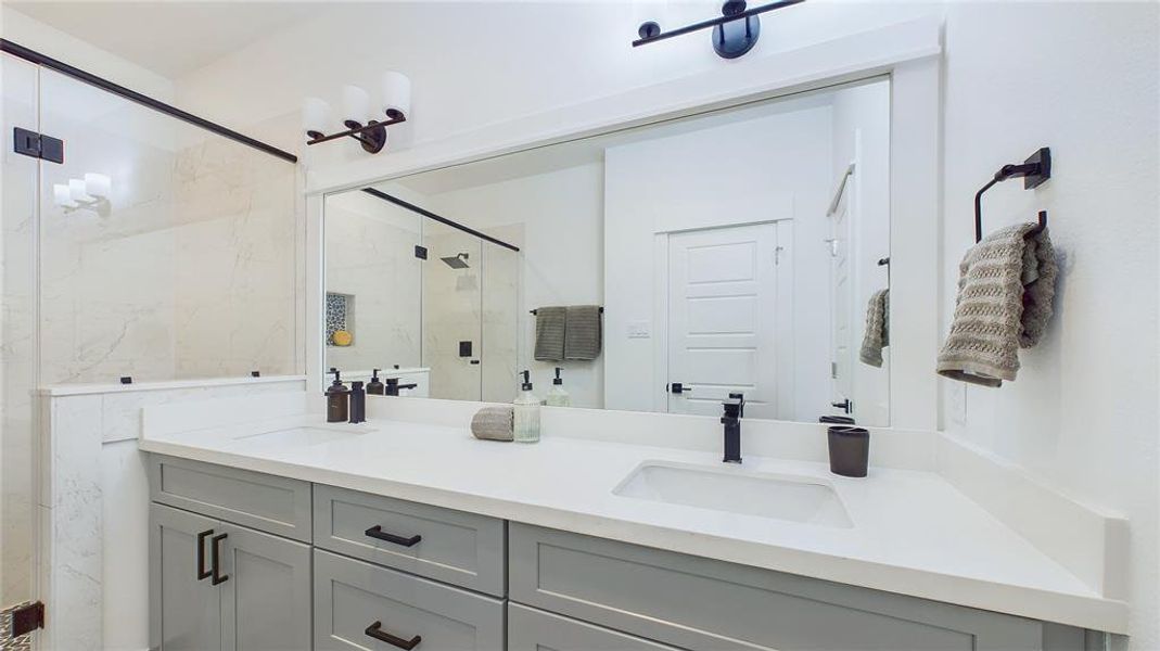 A beautiful primary bathroom featuring a Quartz double sink vanity top, complemented by soft-close drawers and doors.