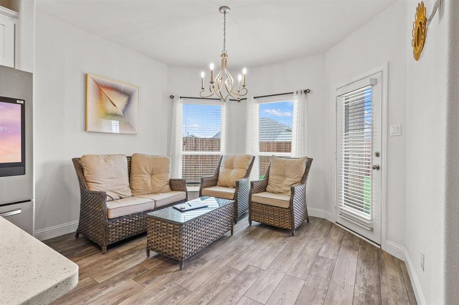 Living room featuring an inviting chandelier and hardwood / wood-style floors