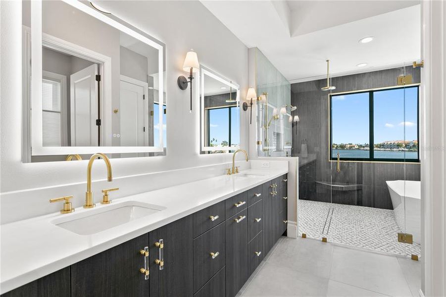 Primary en suite bath with double vanity/ rain shower and soaking tubs w/ expansive water views