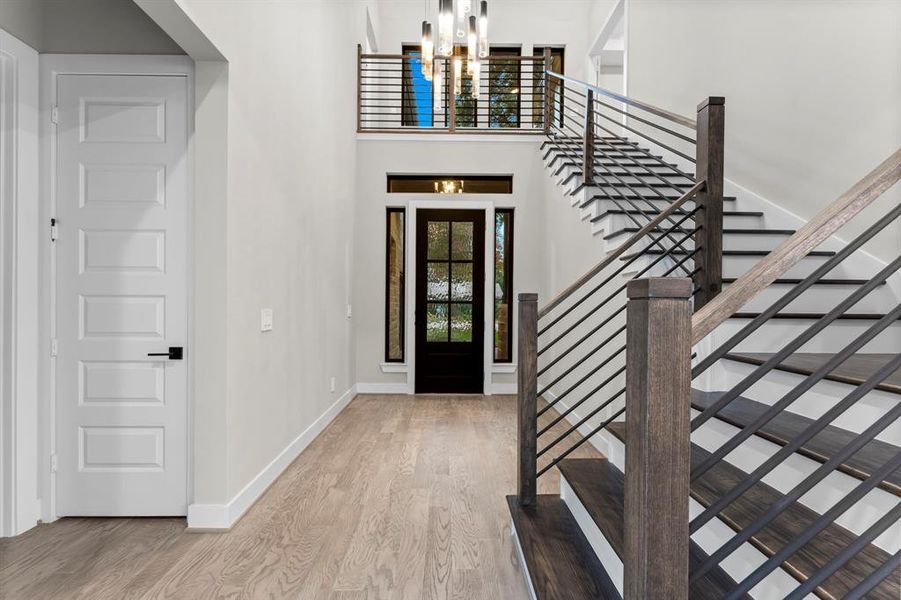 Gazing back at the entrance reveals the charming transitional staircase and the impressive double-height ceiling.