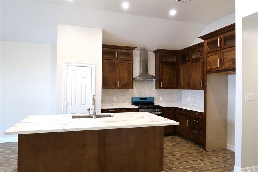 Custom built wood kitchen with quartz countertops.