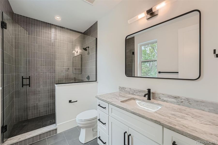 Attached bath with huge walk-in shower for third bedroom.