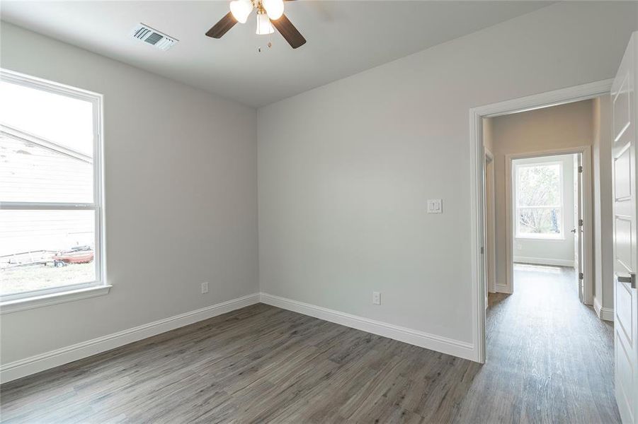 Unfurnished room featuring hardwood / wood-style flooring and ceiling fan