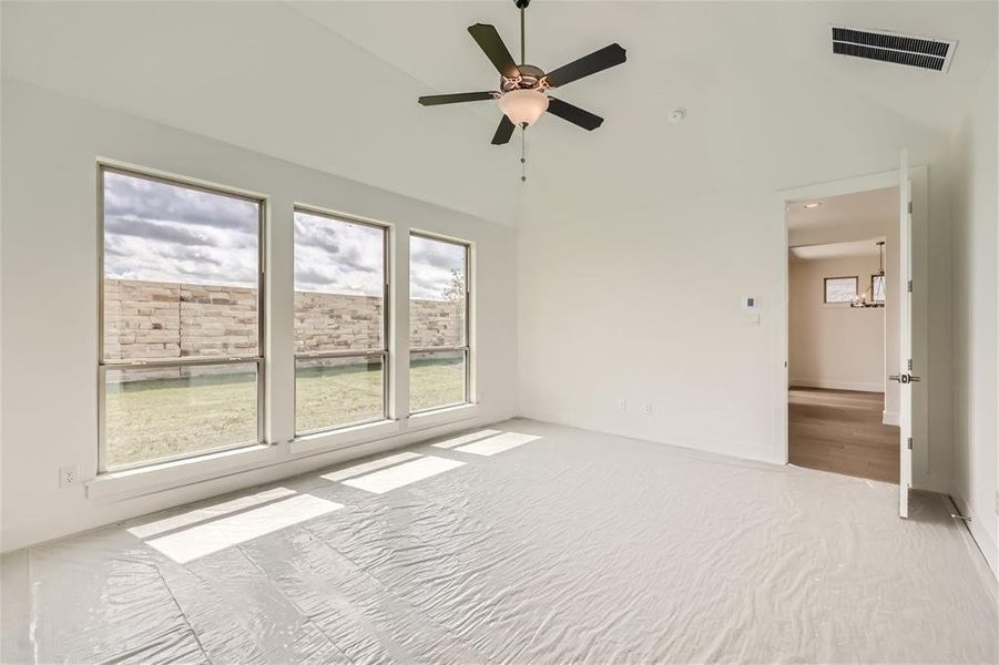 Unfurnished room with high vaulted ceiling and ceiling fan