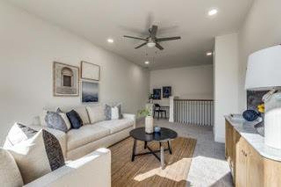 Living room with carpet and ceiling fan