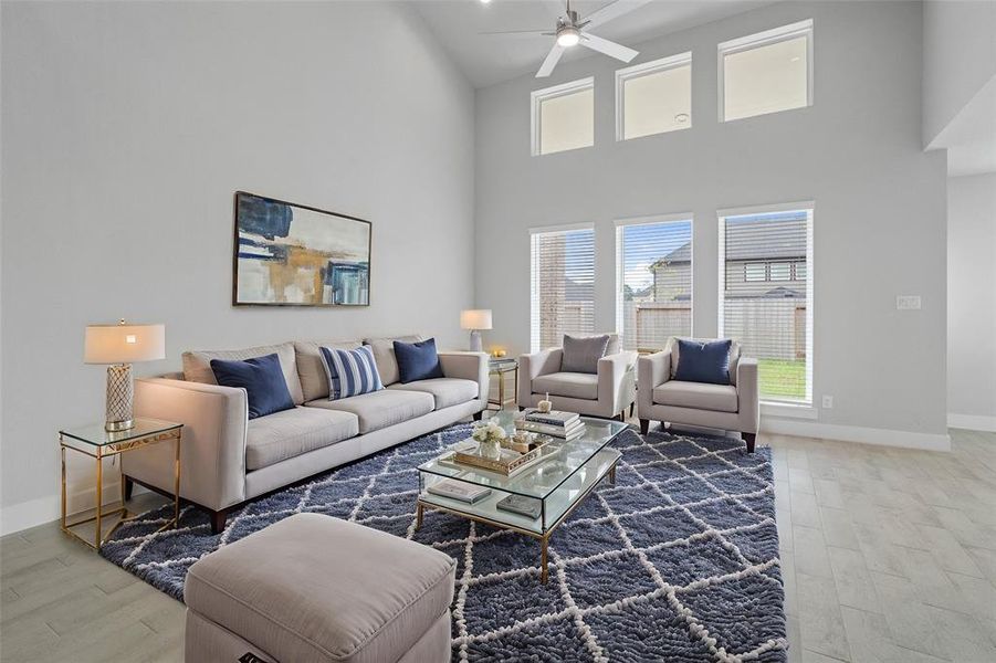 Gather the family and guests together in your lovely living room! Featuring high ceilings, recessed lighting, ceiling fan, custom paint, gorgeous tile floors and large windows that provide plenty of natural lighting throughout the day.