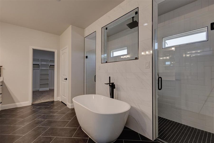 Bathroom with tile walls, shower with separate bathtub, and tile patterned floors