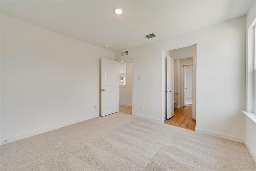 Unfurnished bedroom featuring light carpet