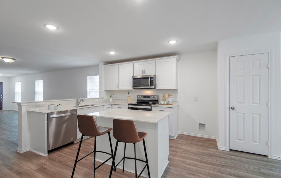 Kitchen featuring a large island ideal for inform