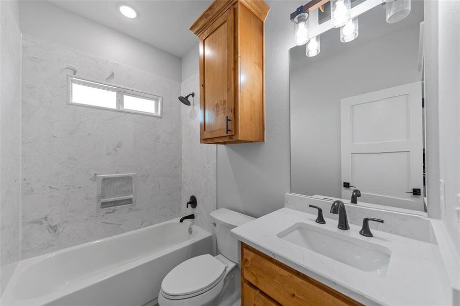 Full bathroom with vanity, shower / bath, and toilet