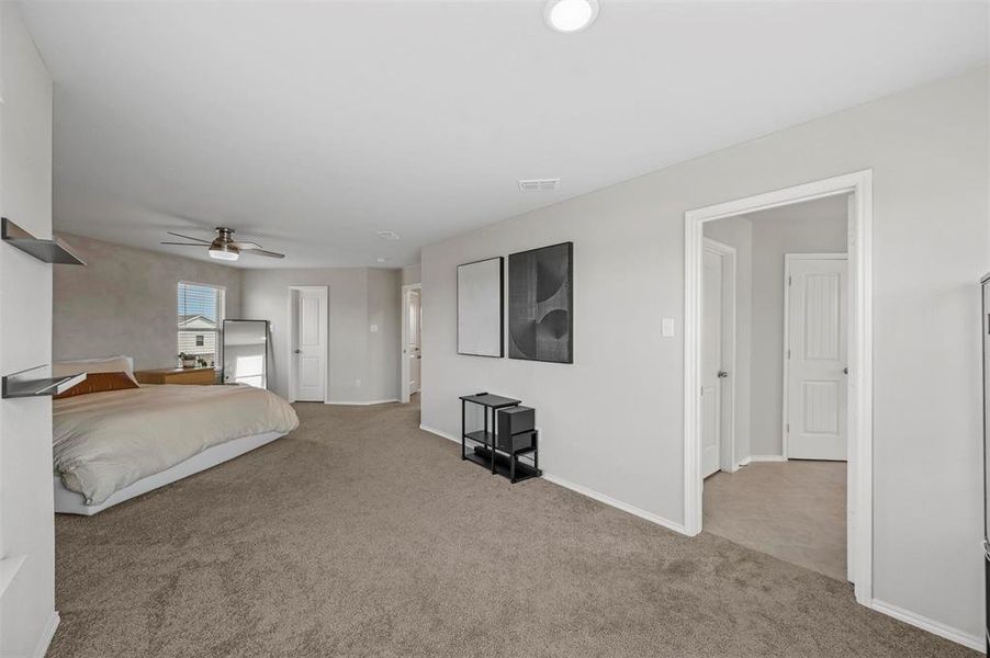 Unfurnished bedroom with light carpet and ceiling fan