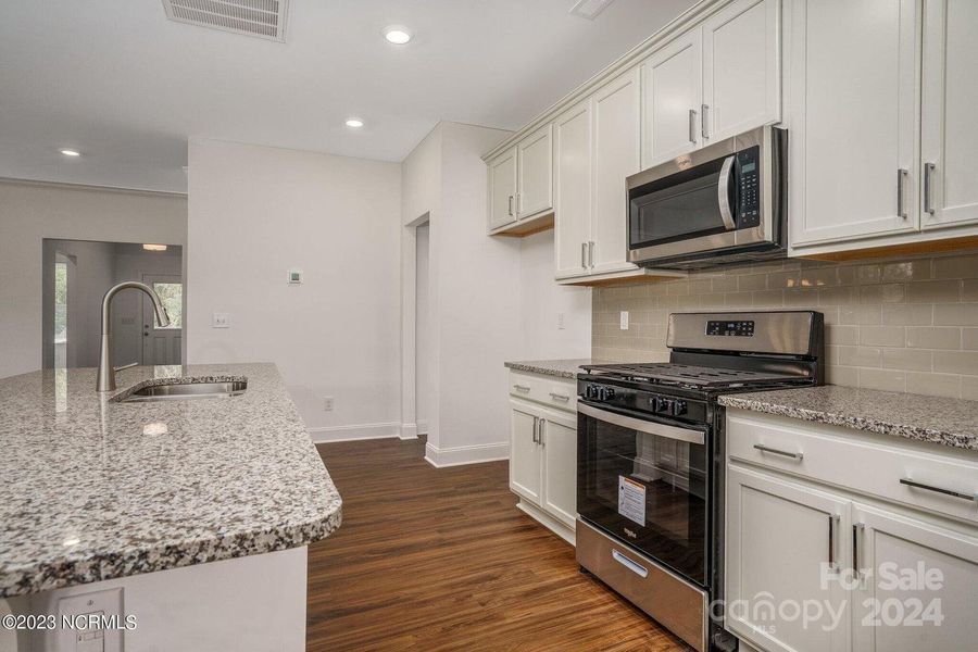 Concept photo of Upgraded Kitchen with granite counters, stainless steel appliances, large center island with seating, pantry, recessed lights & plenty of cabinets for storage!