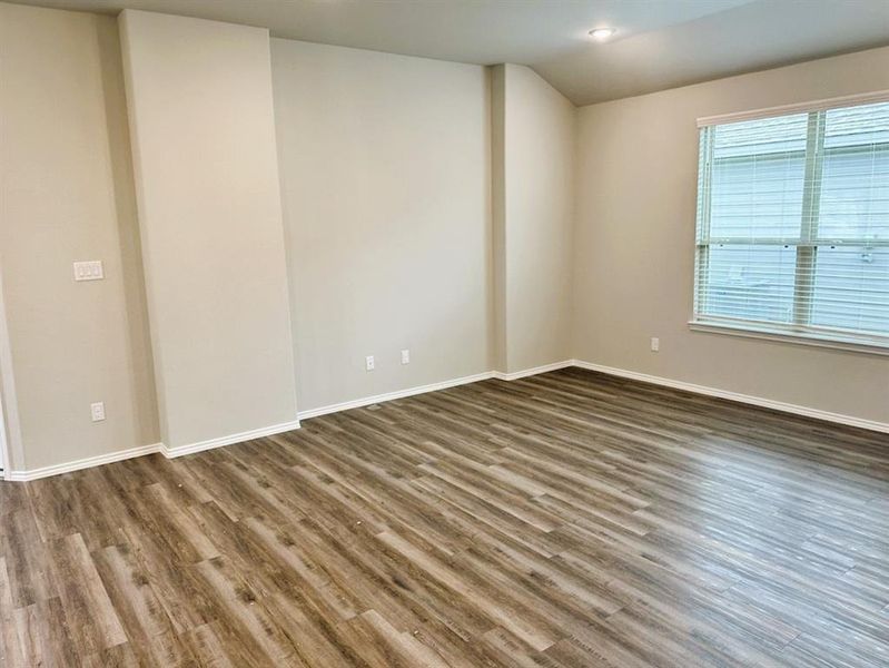 Another view of your living room featuring vaulted ceilings & entertainment niche!