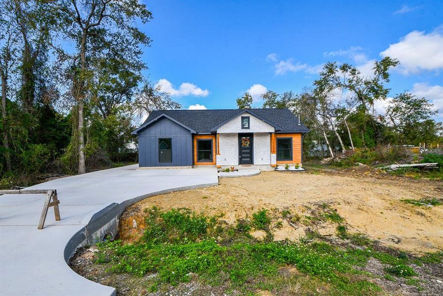 This home features an expansive concrete driveway that welcomes you with ample space, guiding you to the charming entrance. Nestled at the rear of the property, the single-car garage adds convenience and a touch of privacy, making this layout both functional and inviting.