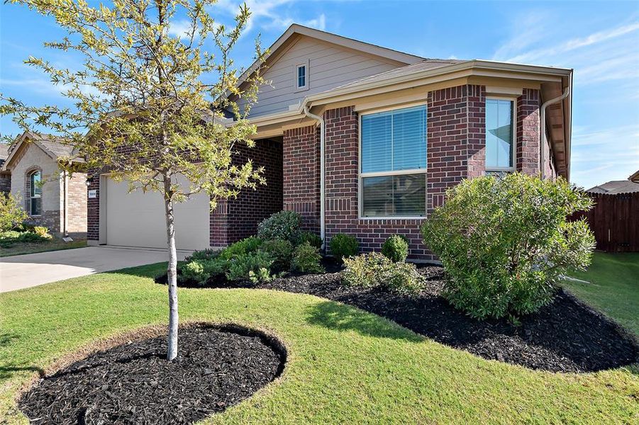 View of front of home featuring a front yard and a garage