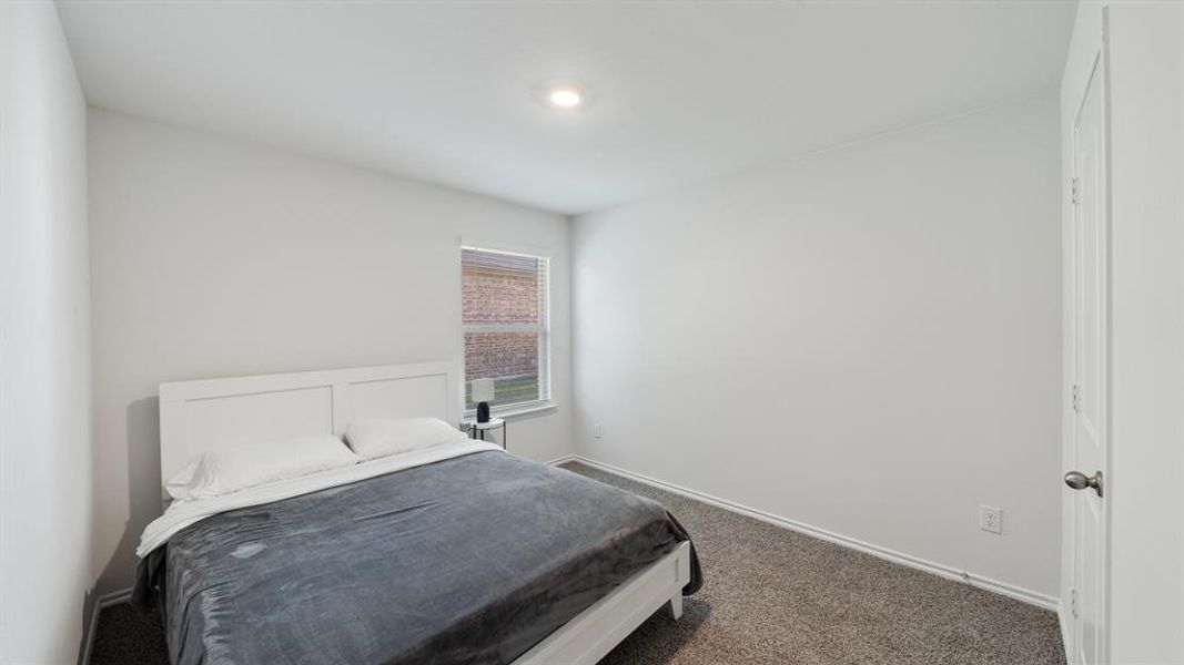 Bedroom featuring dark colored carpet