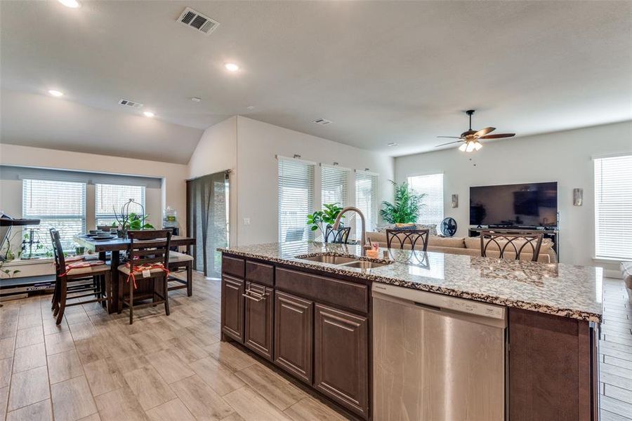 Kitchen with dishwasher, ceiling fan, plenty of natural light, and sink