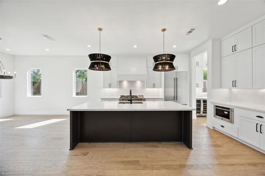 Open concept kitchen with breakfast bar and JennAir appliances