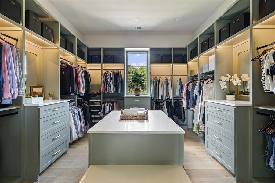 Gorgeous walk-in closet with accent lighting