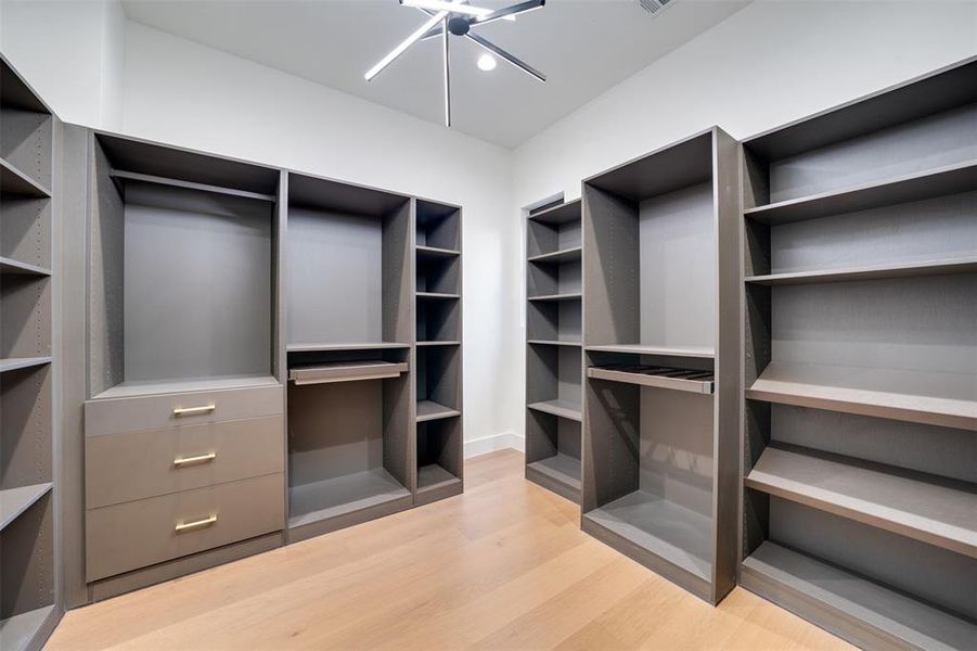 Spacious closet with light hardwood / wood-style floors