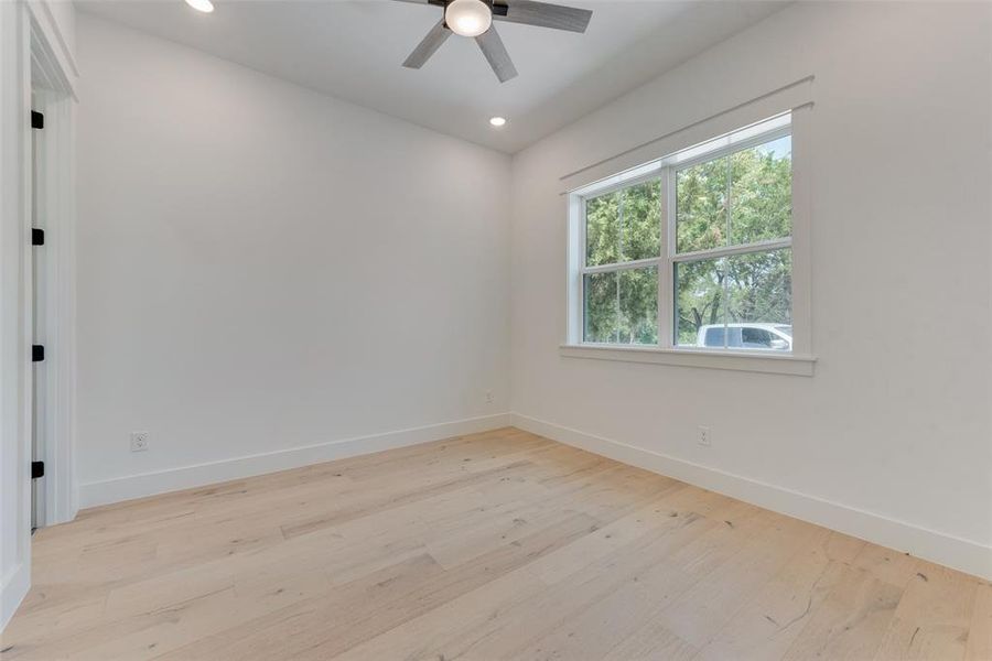 Spare room with light wood-type flooring and ceiling fan