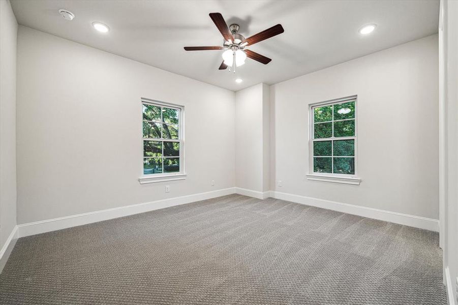 Each secondary bedroom offers a private oasis for rest and relaxation, featuring ample space, plush carpeting, and large windows that flood the rooms with natural light.