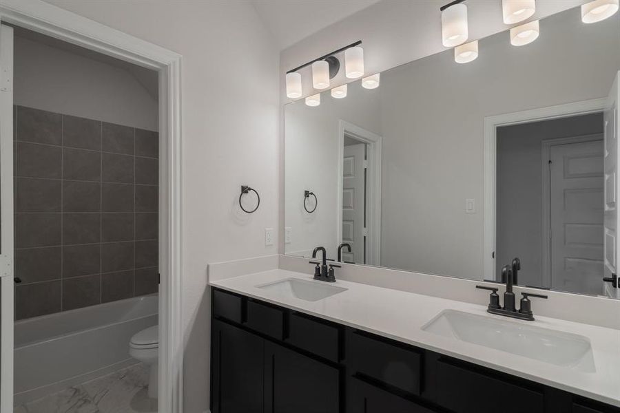 Full bathroom featuring vanity, toilet, and bathing tub / shower combination