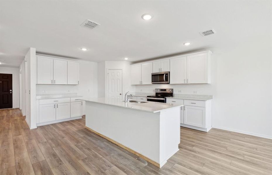 Bright kitchen with large island *real home pictured