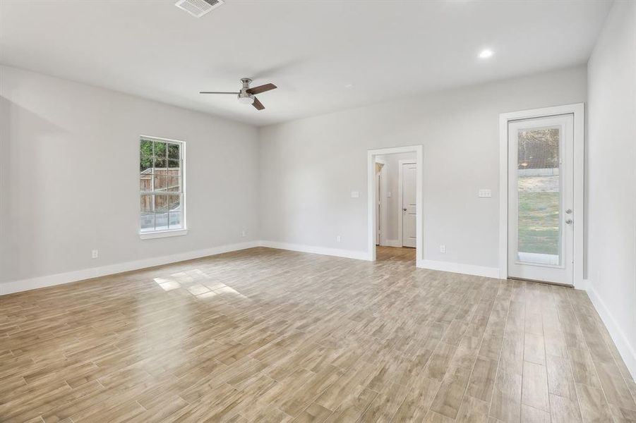 Unfurnished room featuring ceiling fan and light wood-type flooring