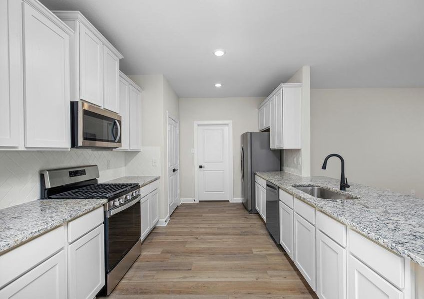 Chef ready kitchen with white cabinets and stainless steel appliances