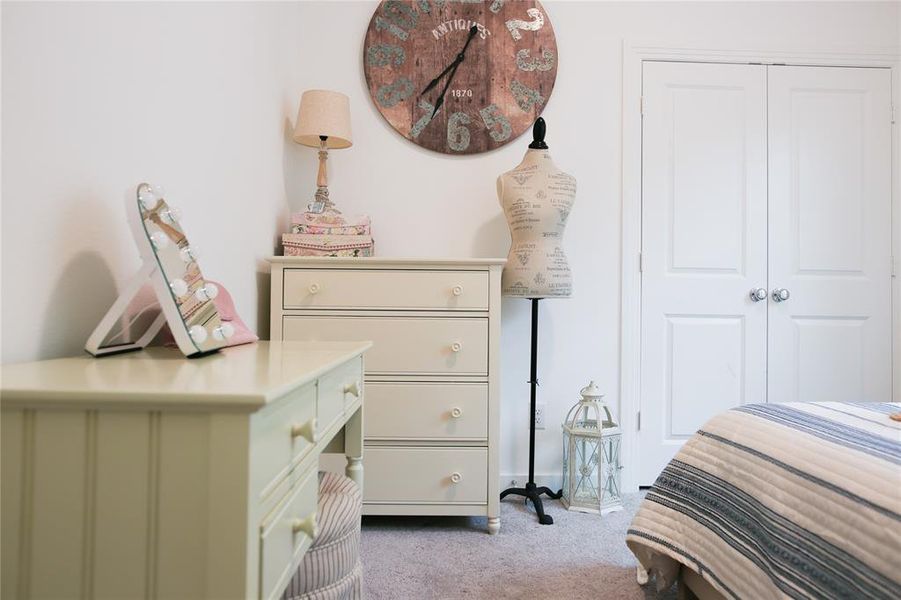 Carpeted bedroom with a closet