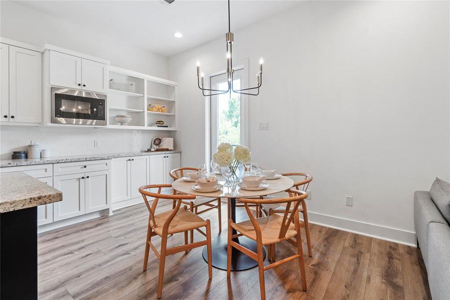 Dining area is a charming space located near the back door. Perfect for intimate meals, this cozy nook offers easy access to the backyard and patio for seamless indoor-outdoor living