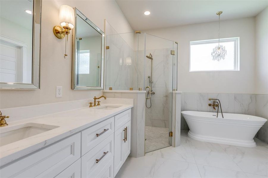 Bathroom featuring tile patterned flooring, shower with separate bathtub, dual vanity, and an inviting chandelier