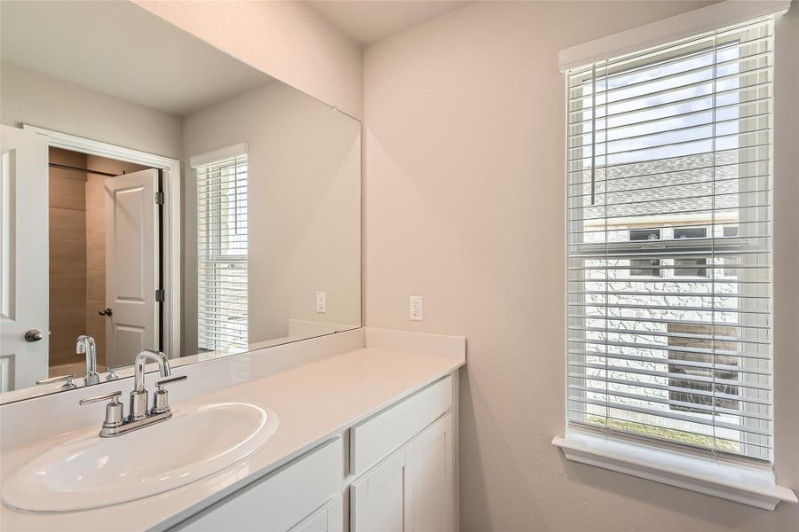 The full secondary bathroom upstairs is located alongside the secondary bathrooms and comes with a spacious single vanity.