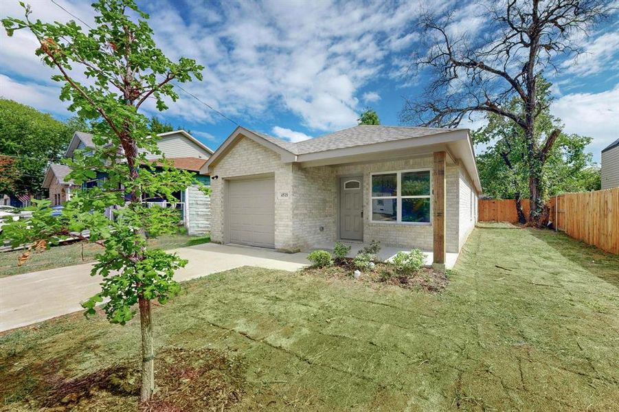 View of front facade with a front yard and a garage