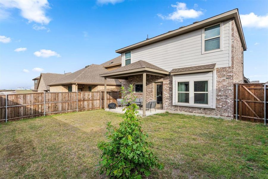 Back of house featuring a yard and a patio area