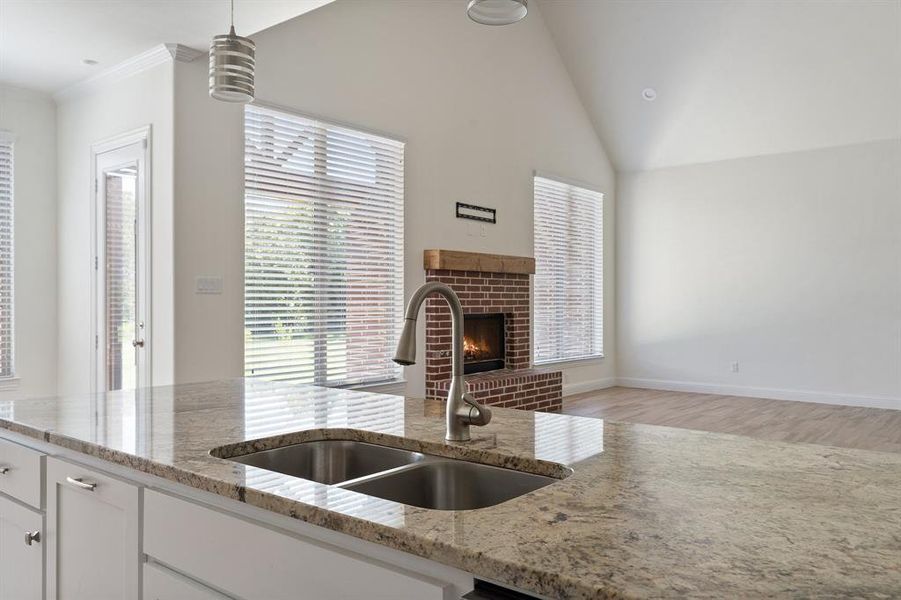 Kitchen featuring sink, pendant lighting, a wealth of natural light, and lofted ceiling